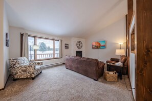 Bright living area with ample seating, Smart TV, and fireplace
