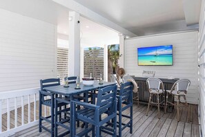 The outdoor patio is the perfect spot to relax and unwind, featuring dining table, bar and 75" TV for outdoor entertainment.