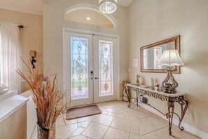 - Step into a bright and welcoming entryway featuring elegant glass doors and tile flooring
- Decorative touches and stylish furniture create a warm, inviting first impression
- Perfect blend of charm and sophistication to greet every guest