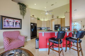 - Bright kitchen bar area with high top seating, perfect for casual meals and morning coffee
- Open floor plan connects kitchen, dining, and lounging spaces effortlessly
- Fun pops of color and cozy accents create a lively, welcoming vibe