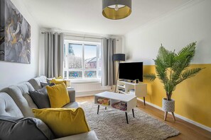 Comfy sofa beds, entertainment on demand, and a peaceful vibe make this living room a guest favorite! 🎬💤