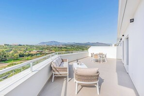 Two terraces—one with seating and dining, another private in the main bedroom.
