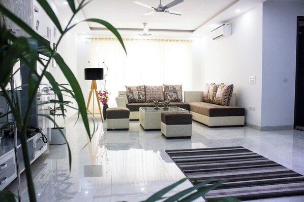 This lavish living room boasts high-end furnishings, exquisite decor, and top-notch amenities, radiating elegance and opulence. Your perfect escape on Parfait Street