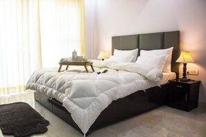 Parfait Street Tranquility: Unwind in this cozy bedroom retreat, where a soothing cup of tea awaits on the bedside table, creating a welcoming and comforting ambiance