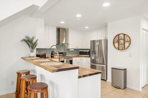 Newly remodeled kitchen with acacia wood counter tops and new appliances