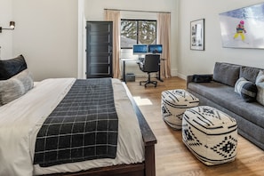 Queen bed with an additional sofa sleeper and a computer desk