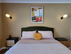 Queen bed in second bedroom with dual robes and dressing table. Motorised blockout blinds.