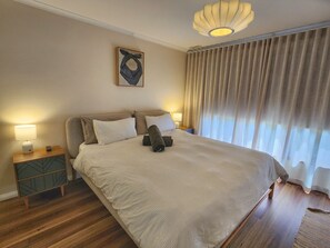 King bed in master with large robes. Outlook towards Donna Buang. Motorised blockout blinds.
