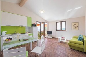 Living room (dining table, kitchen, TV, sofa)