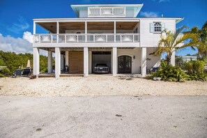Front exterior w/ gorgeous arched doors & carport - Tesla EV charging available