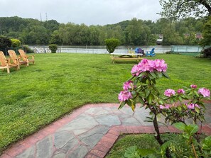 The backyard overlooking the river is an ideal spot to savor your morning coffee or relax and recharge as the sun sets