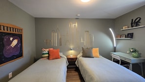 Perfect for the kids or friends, this bedroom features two cozy twin beds