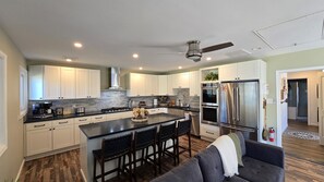 Cook, connect, and create memories in this modern open-space kitchen