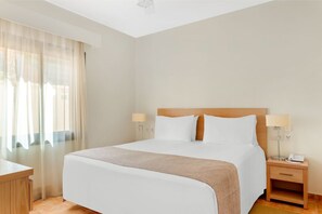 Snug bedroom with ample natural light, creating a warm and inviting atmosphere.