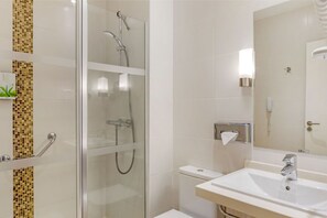 Compact and efficient bathroom with clean lines and a glass shower enclosure.