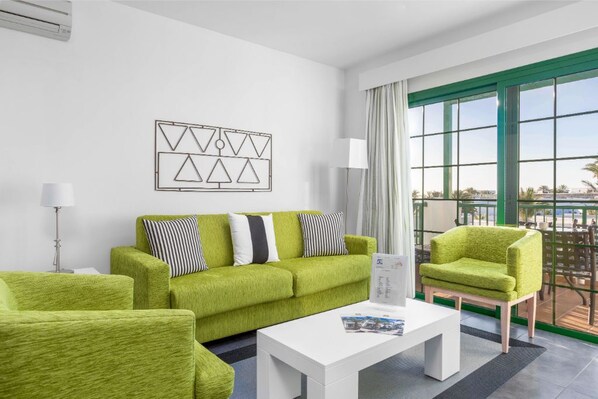 Lounge in a vibrant living area, perfect for relaxation or catching up on your favorite book.