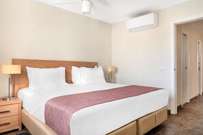 A neatly arranged bedroom with ample space for rest and storage.