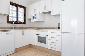 A functional kitchen with the basics for cooking and food preparation.