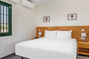 Serene bedroom space with plush bedding for a restful night's sleep.