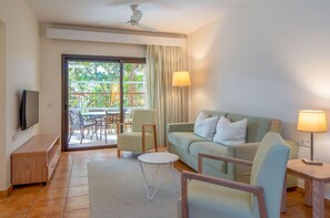 Embrace the tranquility of this spacious living room that opens to nature's embrace on the balcony.