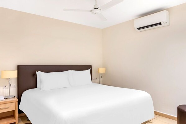 Simple and elegant bedroom with a cozy bed for a restful night's sleep.