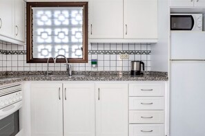Kitchen setup that includes the essentials for preparing meals and snacks.