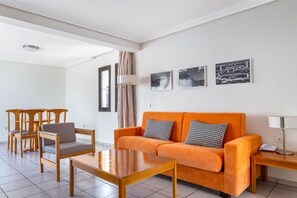 An area where vibrant cushions meet soft lines, inviting rest and conversation.