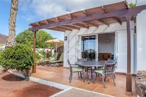 Dine al fresco under the shade of our charming vine-covered pergola.