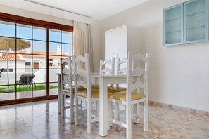 Bright dining area with large windows, perfect for enjoying meals in natural light.