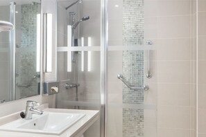 Bright and airy bathroom with a glass-enclosed shower, combining modern design with clean lines.