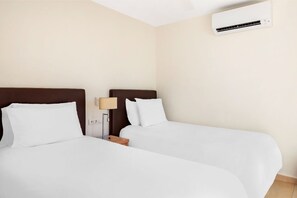 Welcoming bedroom with soft lighting and a homely atmosphere for your rest.