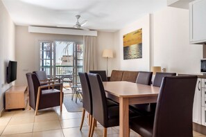 Open-plan living and dining area with ample natural light, perfect for relaxing and socializing.