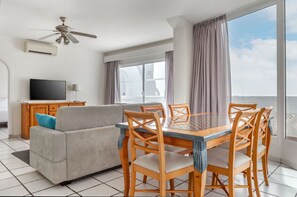 Cozy living and dining area with plenty of natural light, perfect for leisurely mornings or intimate dinners.