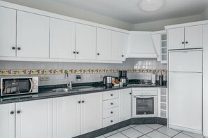 Spacious kitchen with ample countertops, equipped for crafting your favorite dishes.