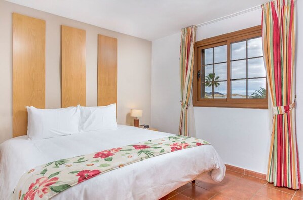Cozy and inviting bedroom with warm lighting and soft, comfortable bedding for a restful night's sleep.
