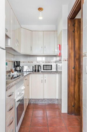 Compact and efficient kitchenette, fully equipped to handle all your basic cooking needs.
