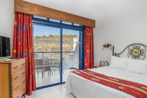 Wake up to stunning mountain views in this cozy, ski-themed bedroom.