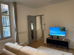 Bright living room with connected TV and printer for your business stays.