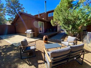 Enjoy the fresh air in this private outdoor space with comfortable seating and beautiful surroundings.