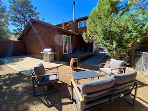 Enjoy the fresh air in this private outdoor space with comfortable seating and beautiful surroundings.