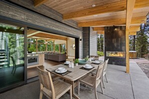Outdoor dining area with Gas fireplace and Grill.