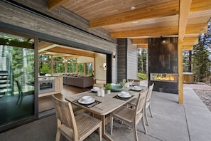 Outdoor dining area with Gas fireplace and Grill.
