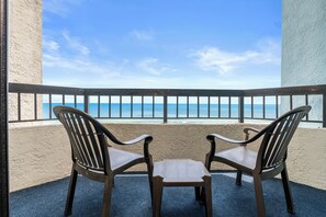 Two balcony chairs facing the ocean for sunrise views