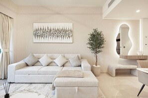 Step into this modern living room, featuring sleek, contemporary furnishings and stylish décor. A spacious and inviting area, perfect for relaxing or entertaining during your luxurious stay in Downtown Dubai.