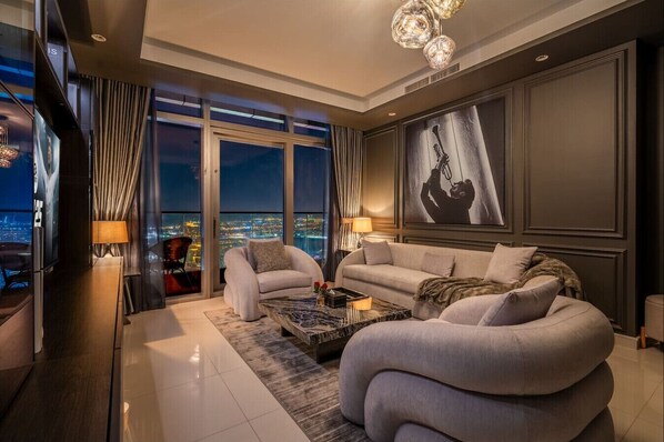 Spacious living room featuring a plush sofa, smart TV, and a stylish coffee table. The perfect space to relax and unwind in the evenings, surrounded by modern decor and a cozy ambiance in the heart of Downtown Dubai.