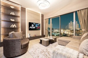 Relax in this stylish, warmly lit living room, featuring modern decor & scenic views that enhance your experience. With a PS5 at your fingertips, enjoy gaming or unwind with a movie. Evenings here are sure to be filled with comfort and entertainment