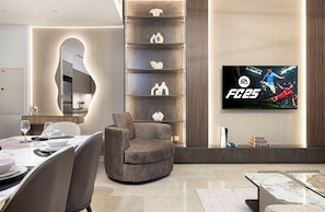 Enjoy a beautifully decorated living room featuring modern furnishings and elegant décor, seamlessly connected to a stylish dining table. This open-concept space offers comfort and sophistication for your luxurious stay in Downtown Dubai.