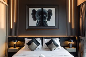 A stylish bed with soft linens, accentuated by modern wall art and LED lighting, creating a cozy and chic ambiance for ultimate relaxation.