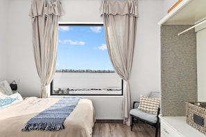 Complemented by a large window showcasing a tranquil lake view.