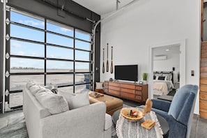 Modern decor includes a comfortable sectional sofa with plush throw pillows and a sleek ottoman.